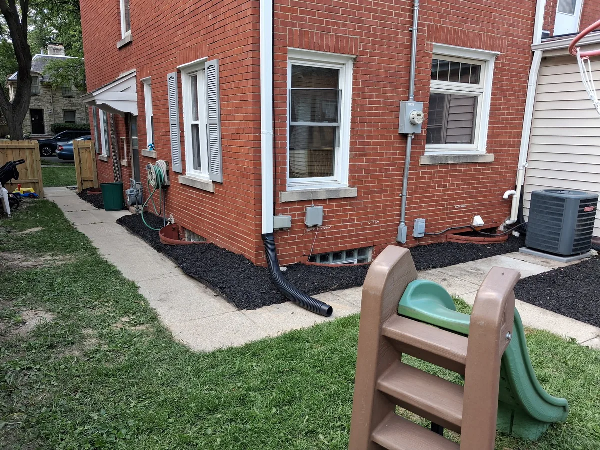 Black mulch bed installed along a home foundation